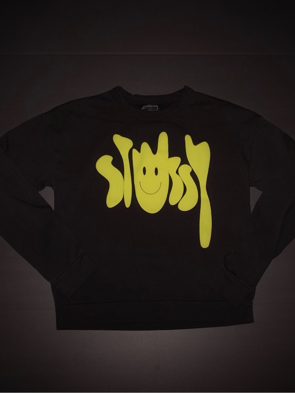 Stüssy black sweatshirt with yellow smiley face graphic, size S